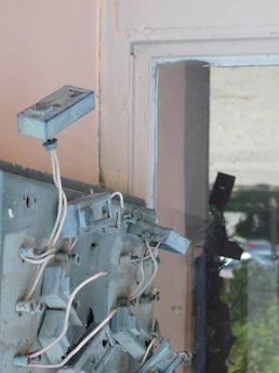 Close-up of rodent droppings and gnawed electrical wires inside a home.