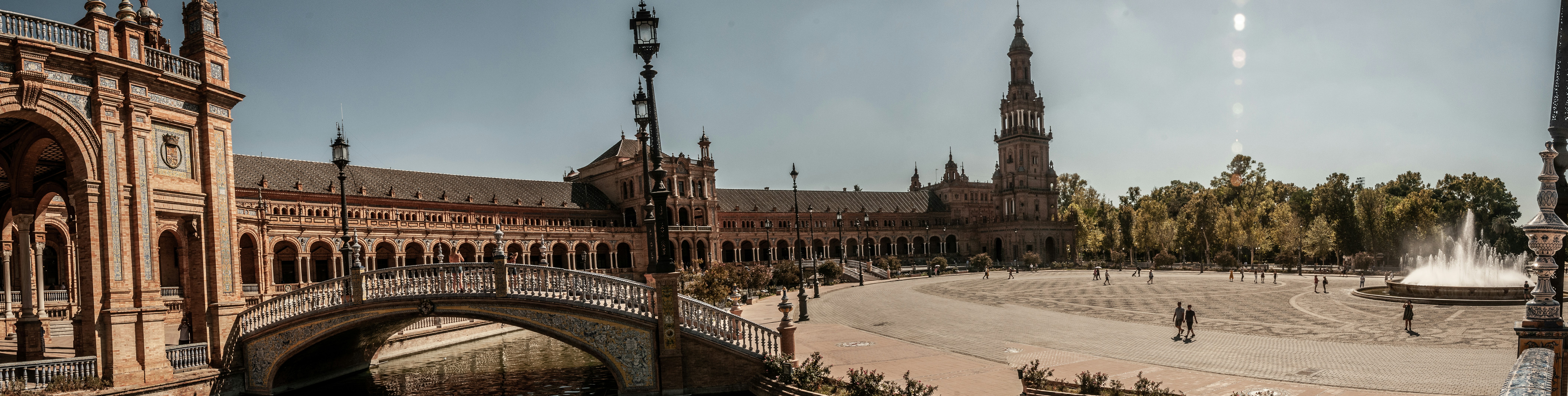 a large building with a fountain in front of it, 