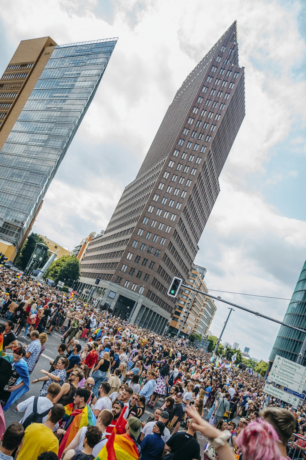 a crowd of people in front of a tall building