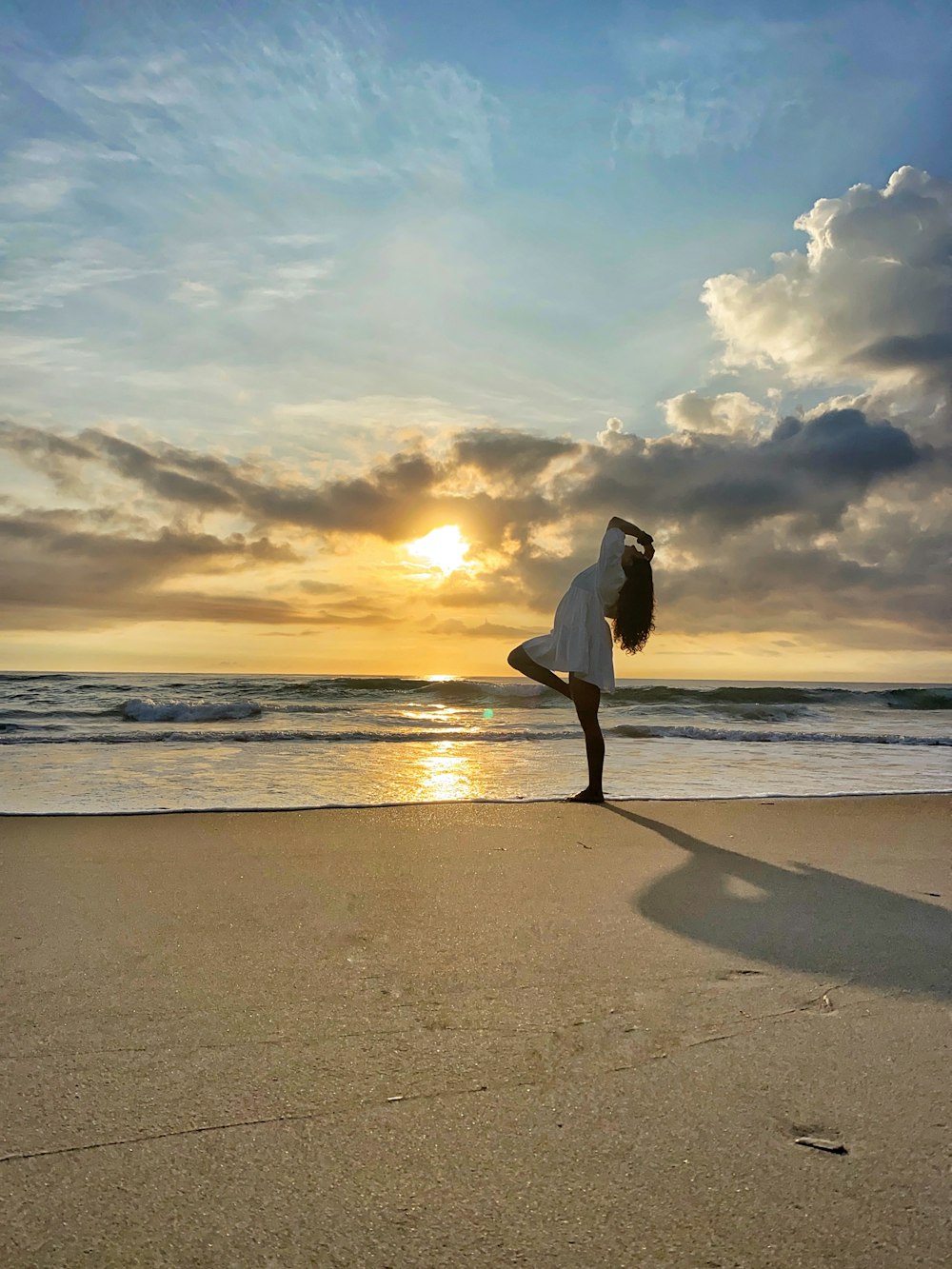 a person carrying a surfboard on a beach