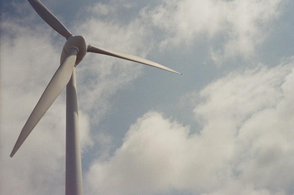 a large windmill with clouds in the background