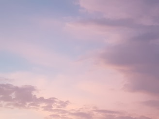 A peaceful image of a sunset sky painted in soft pastel hues, evoking calm and imagination.