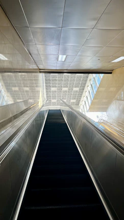 Wide shot of a newly installed escalator in a modern commercial building.