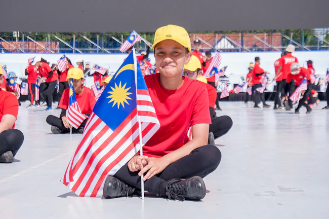 Community members proudly wearing custom t-shirts made by Merahraya in an outdoor event