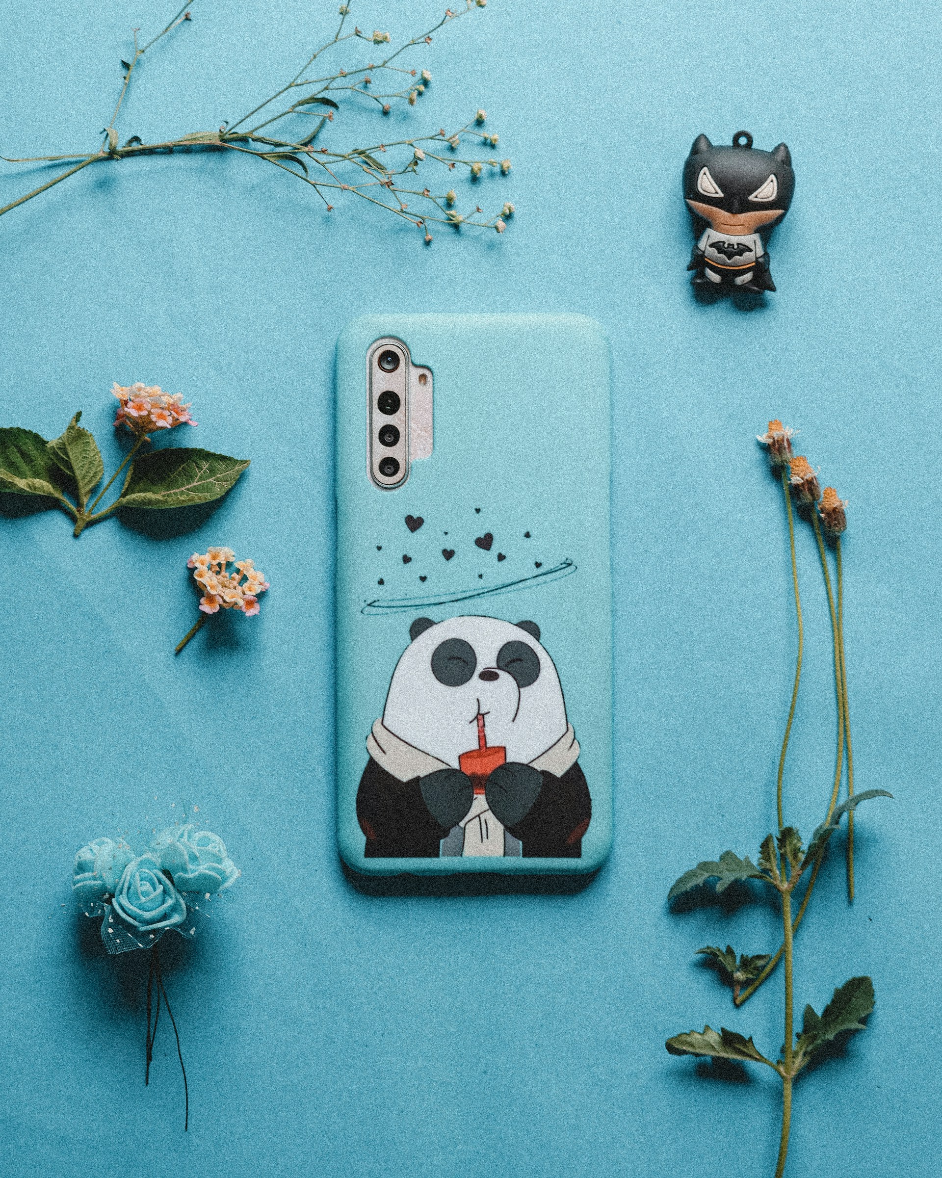 a wall with a picture of a panda and flowers