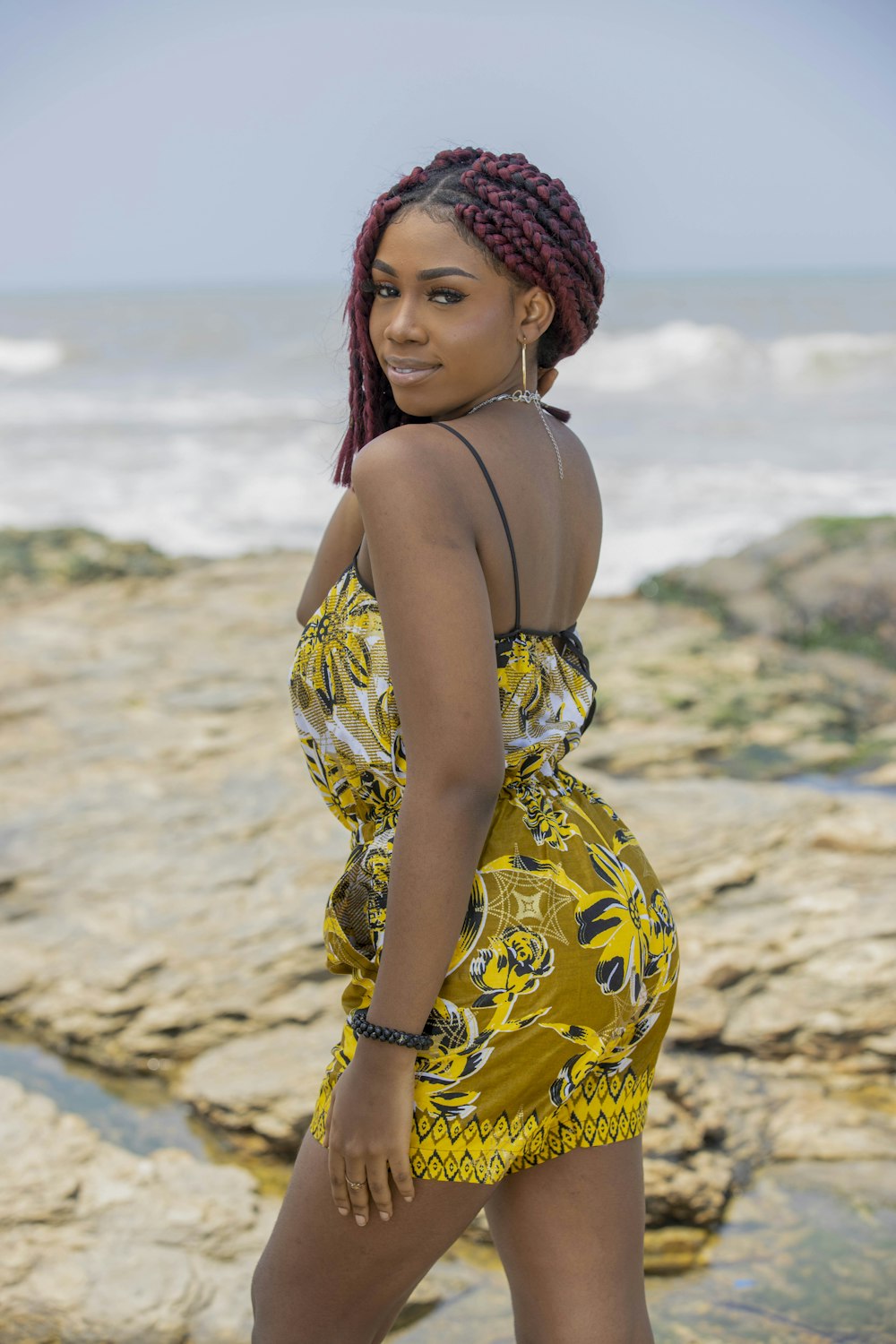 a person in a swimsuit on a rocky beach