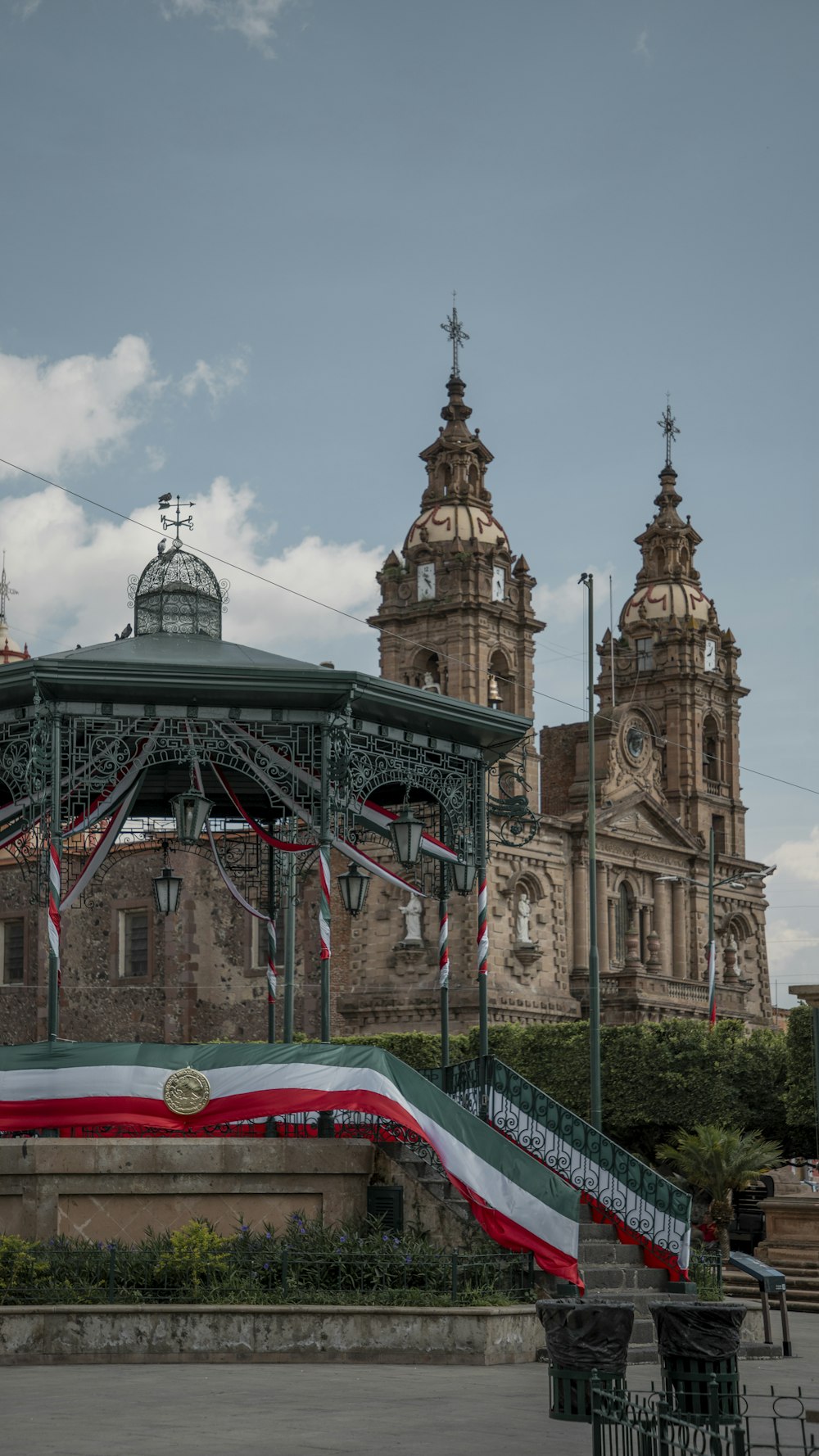 a building with towers and a red roof