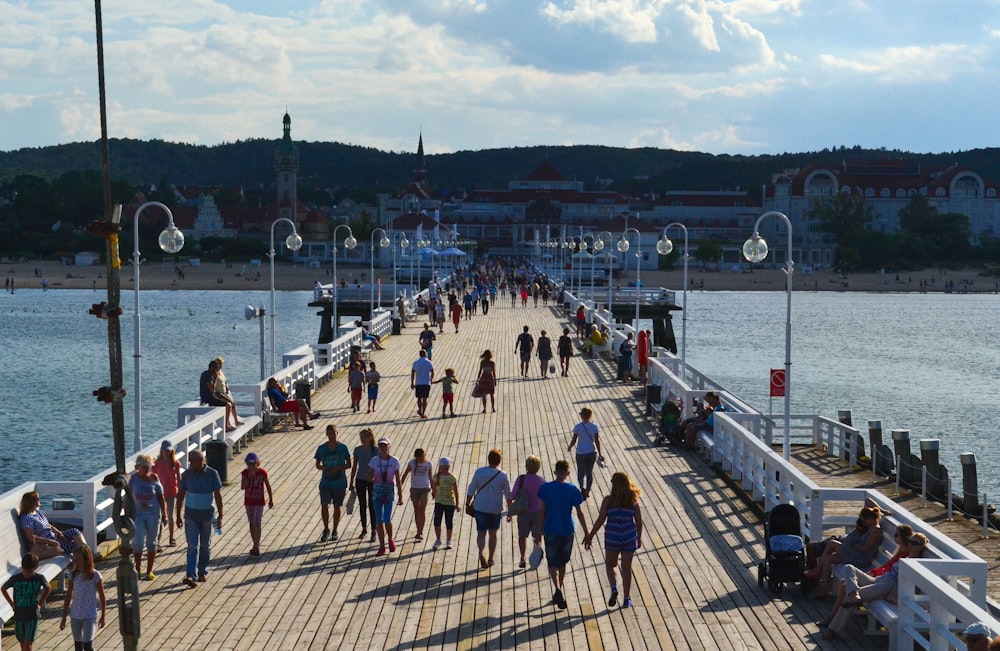 a group of people walking on a dock