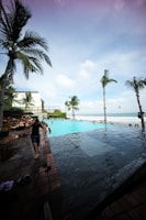 Families enjoying a sunny day at the poolside area.