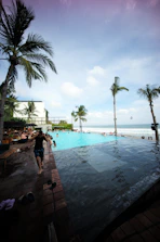 Guests enjoying a sunny day by the sparkling hotel swimming pool.
