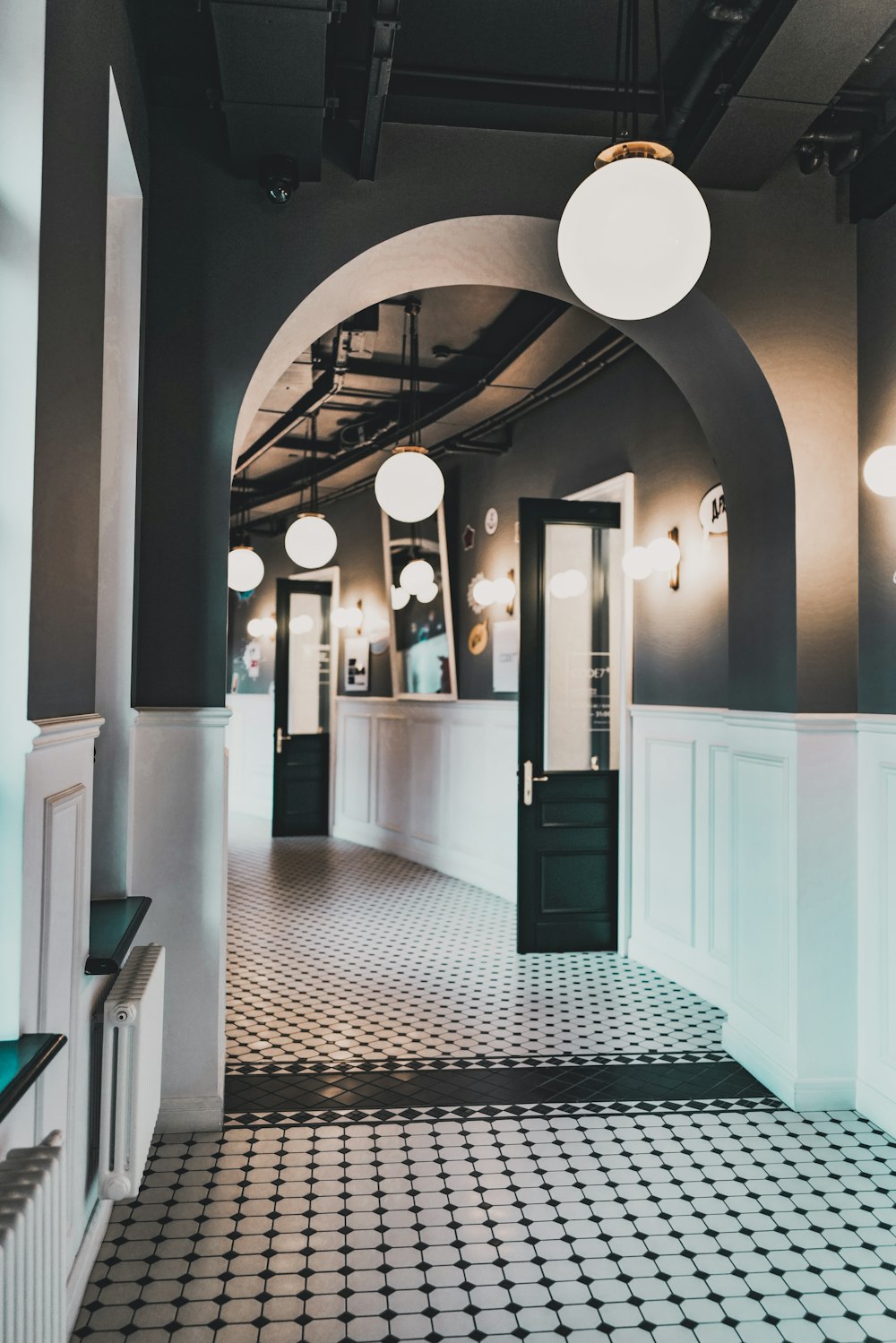 a hallway with white lamps