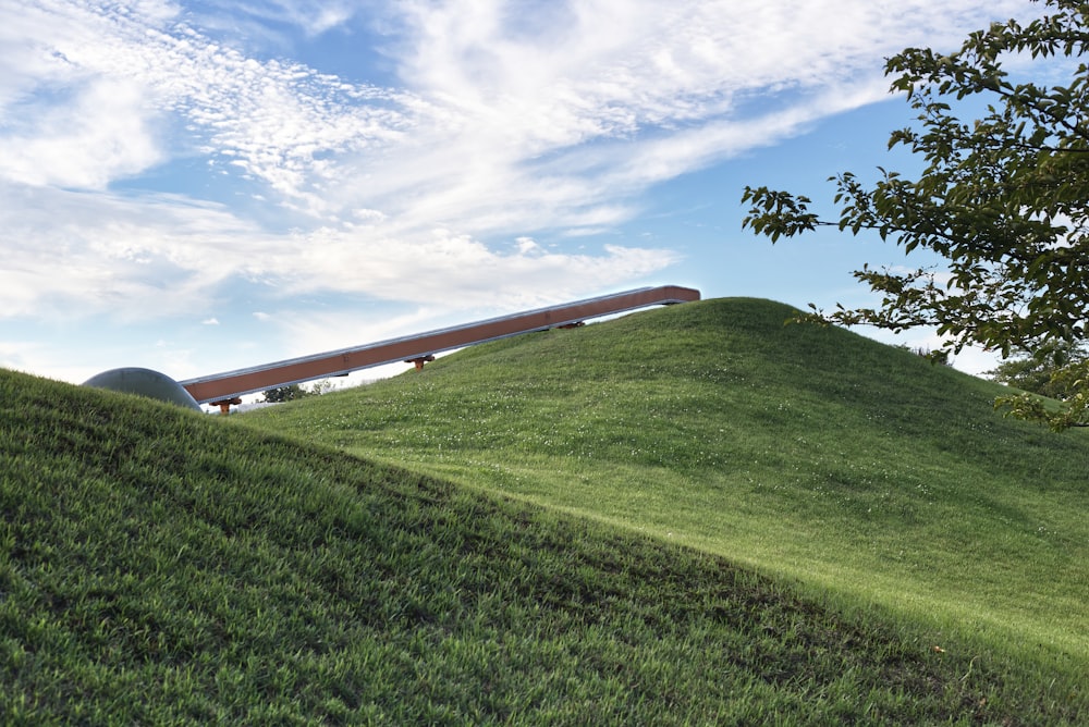 a grassy hill with a building on it