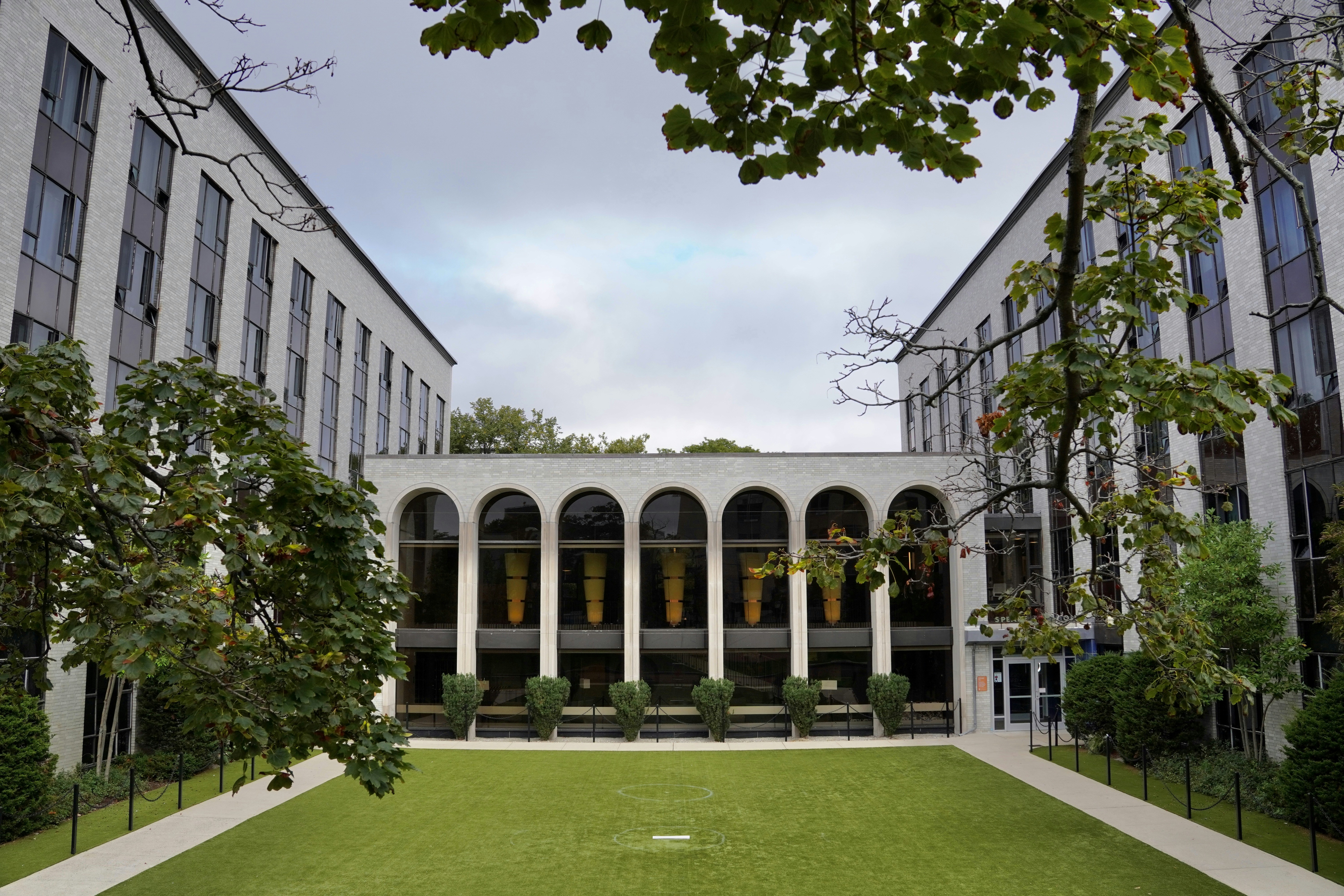 a building with a lawn and trees