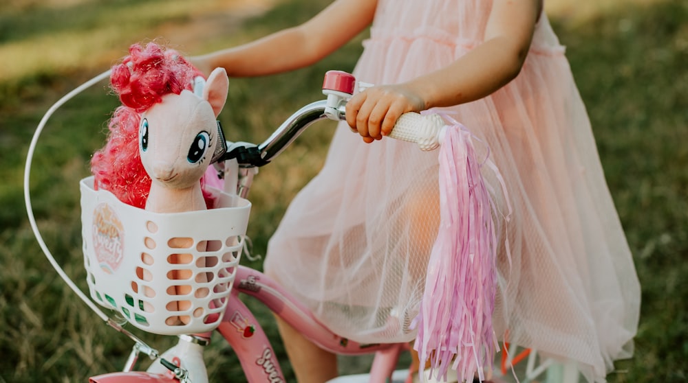 a person riding a bike with a doll on the back