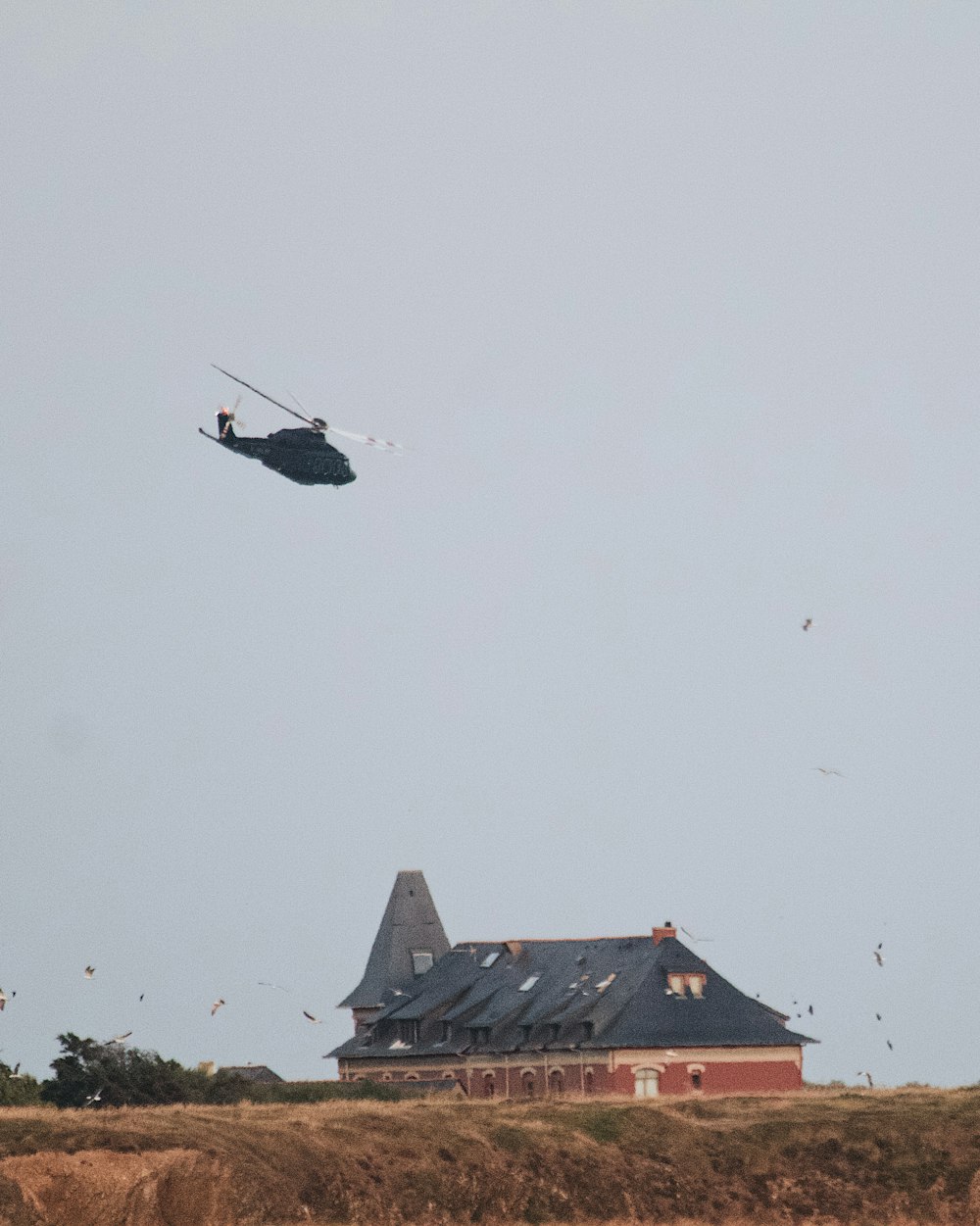 a helicopter flying over a house