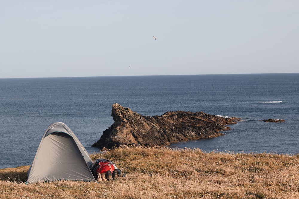 a tent next to a rock