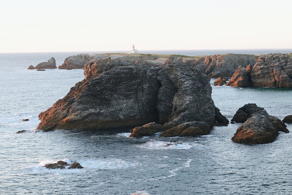 a rocky shoreline with a person on a boat