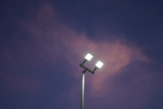 a street light with a purple sky