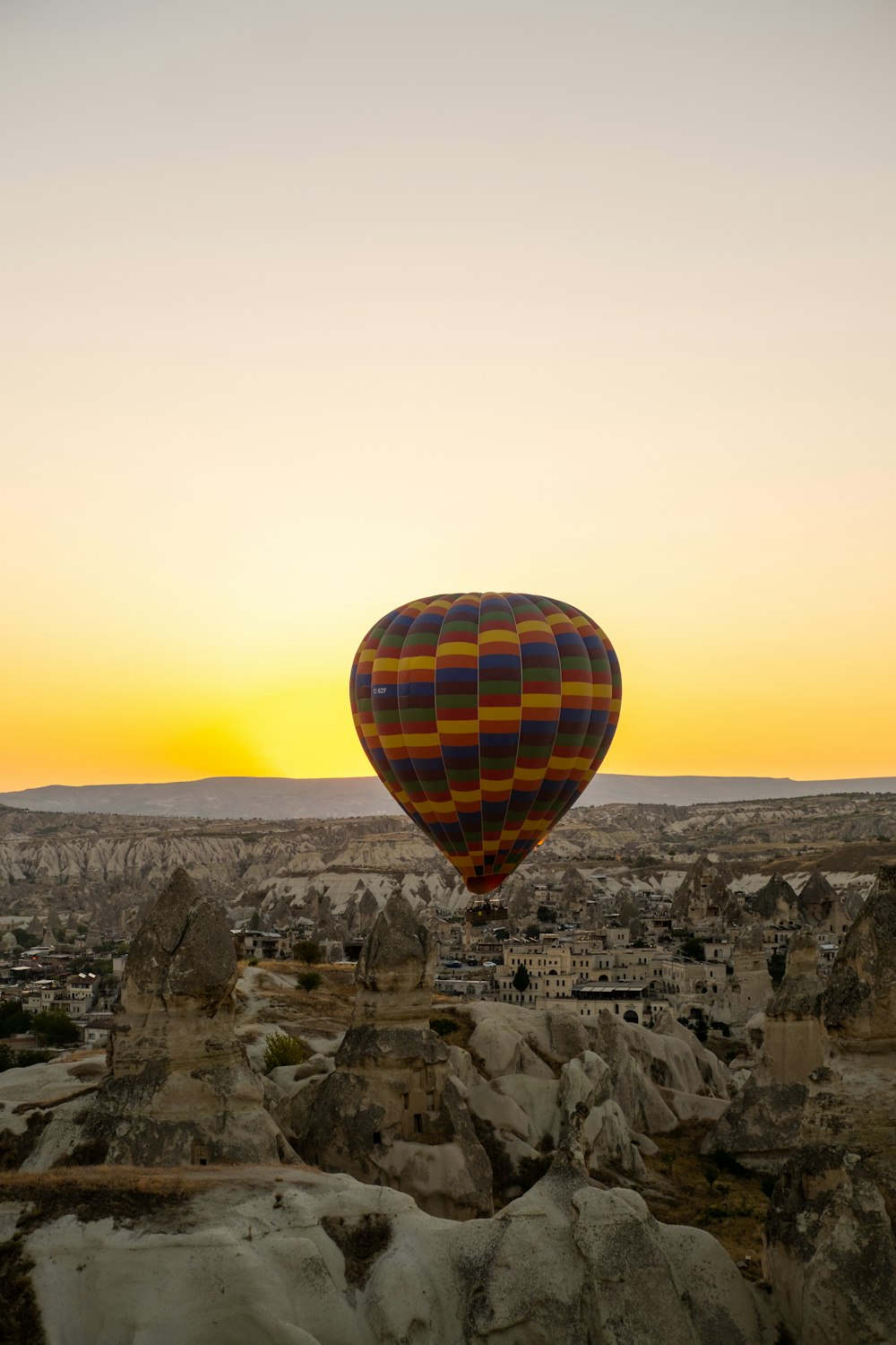 a hot air balloon flying over a city