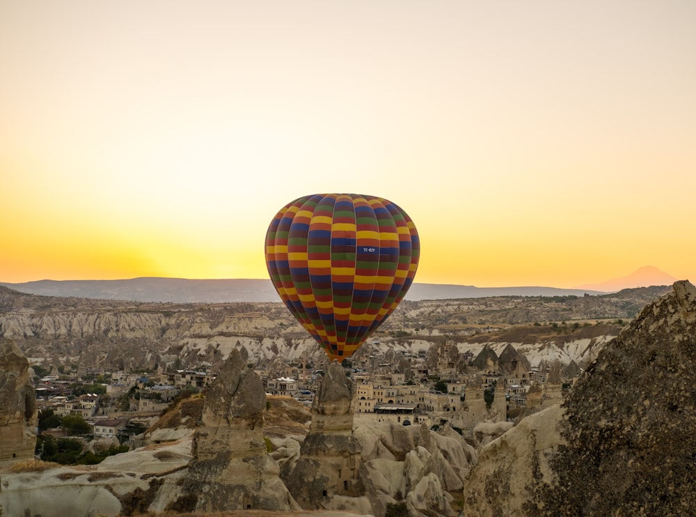 a hot air balloon flying over a city