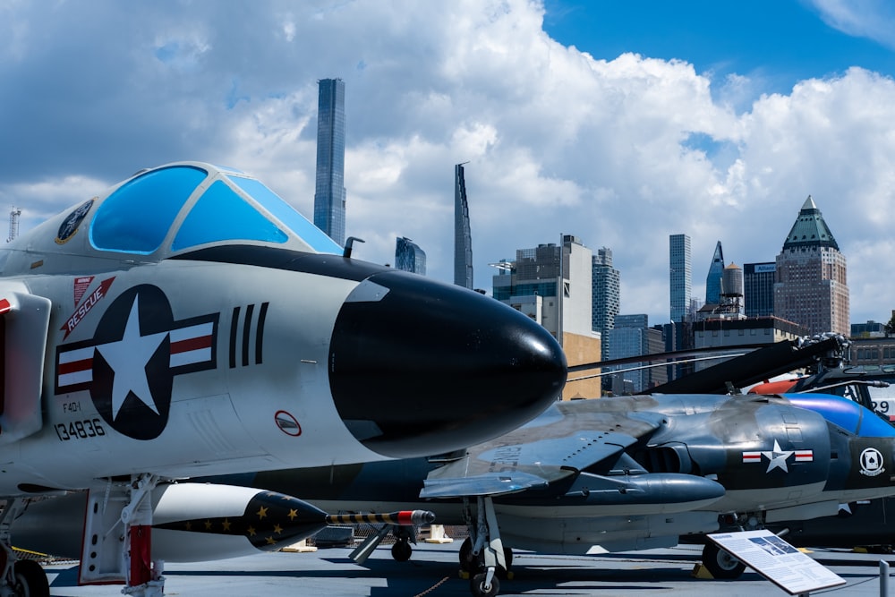 a group of jets parked in front of a city