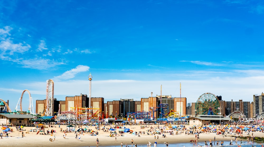 a beach with a ferris wheel in the background