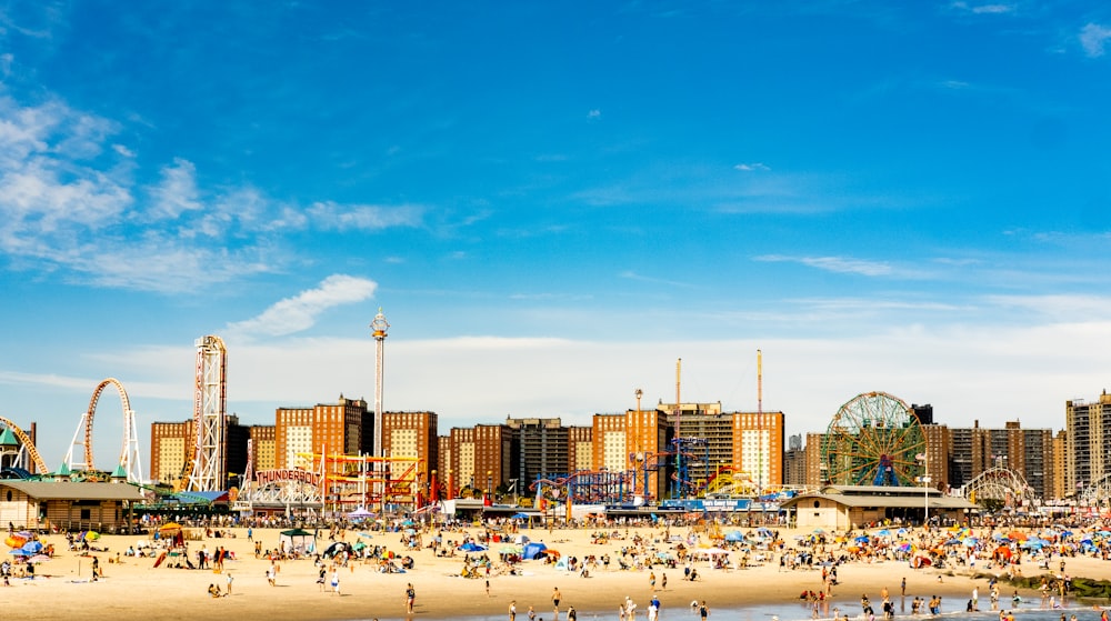 a beach with a ferris wheel in the background