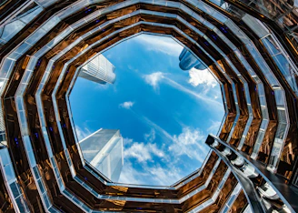 looking up at a blue sky through a window at a building