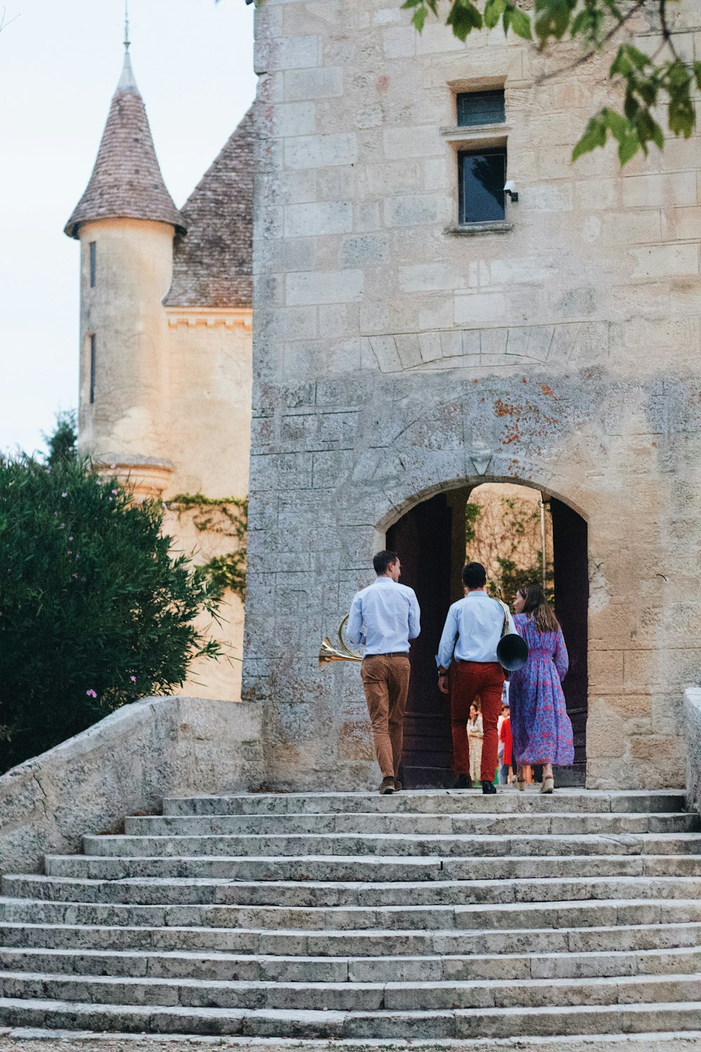 people walking up stairs to a building