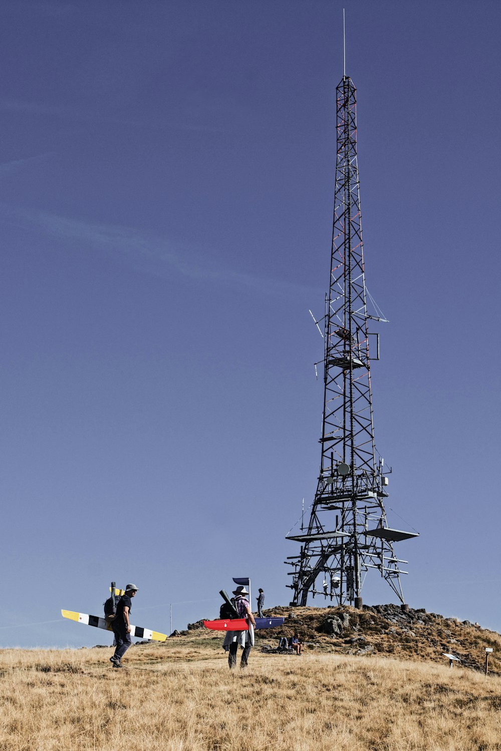 a group of people standing next to a tower