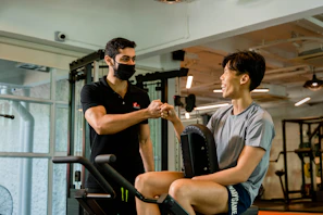 Trainer and member sharing a high-five after completing an intense circuit