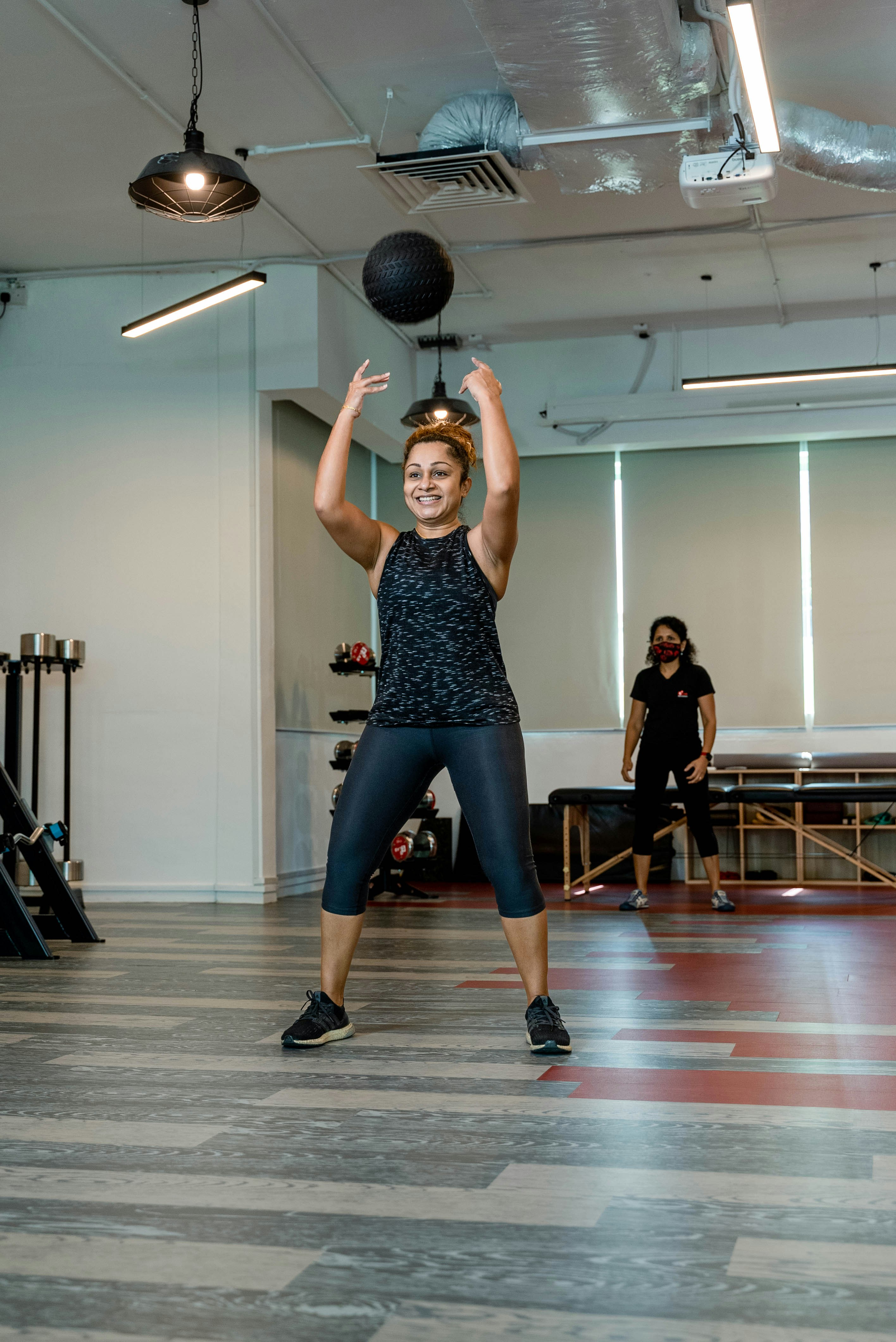 Woman throwing a medicine ball in a gym