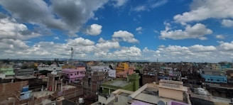 A vibrant cityscape with colorful buildings under a bright sky.