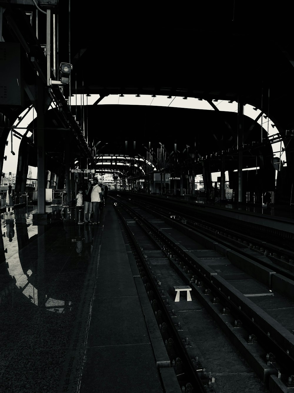 a train station with people waiting