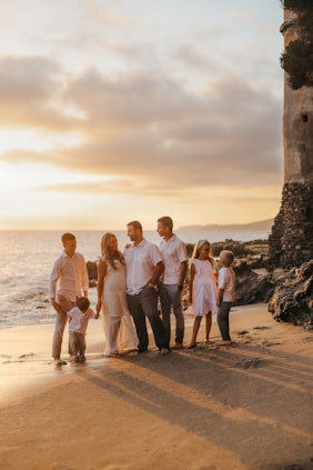 a group of people standing on a beach