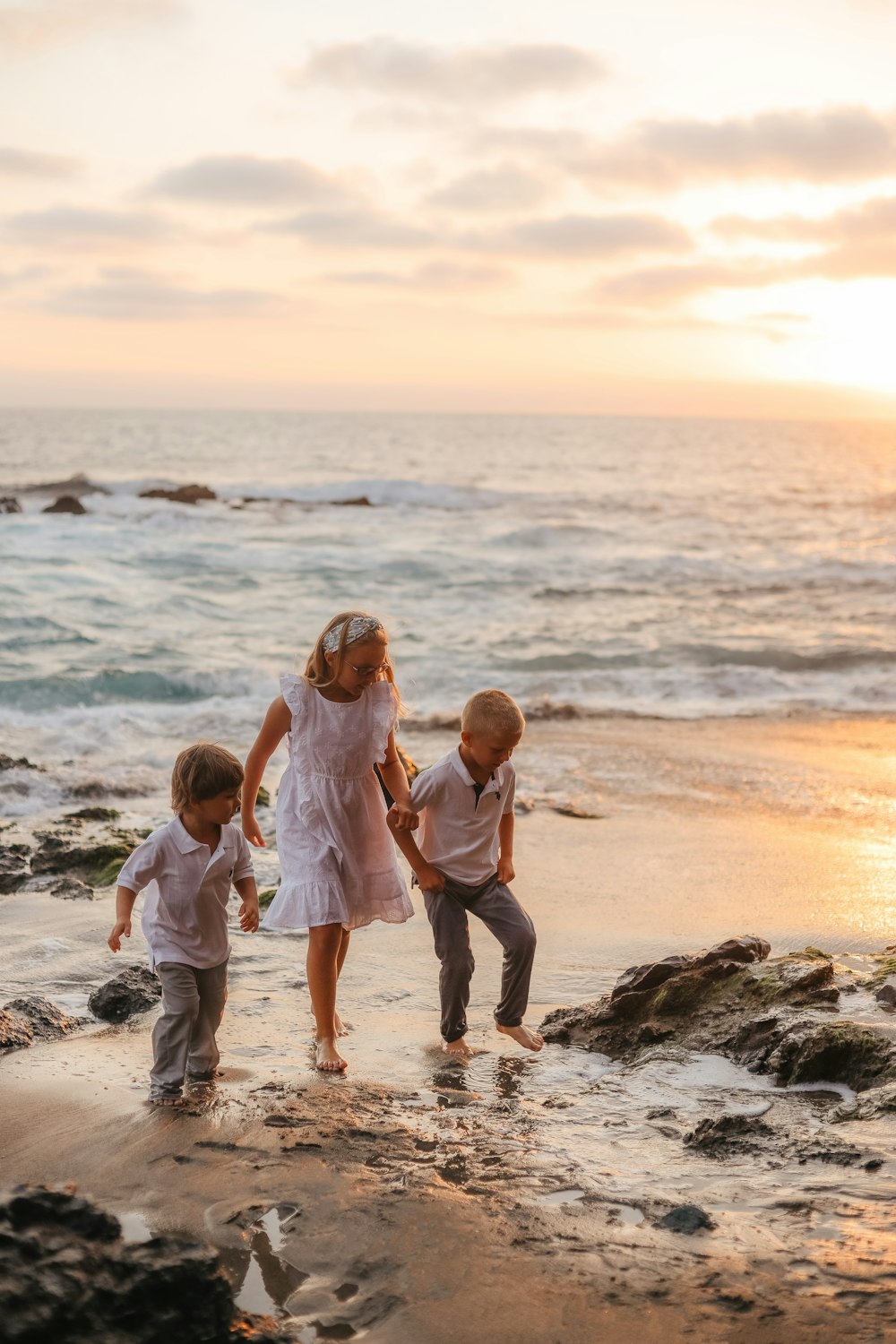 a group of children walking on a beach