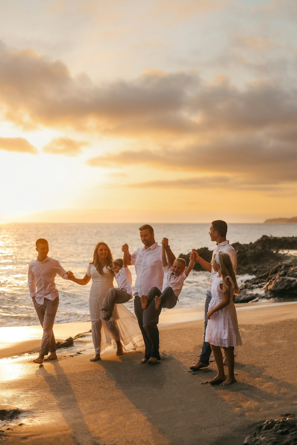 a group of people posing for a photo on a beach