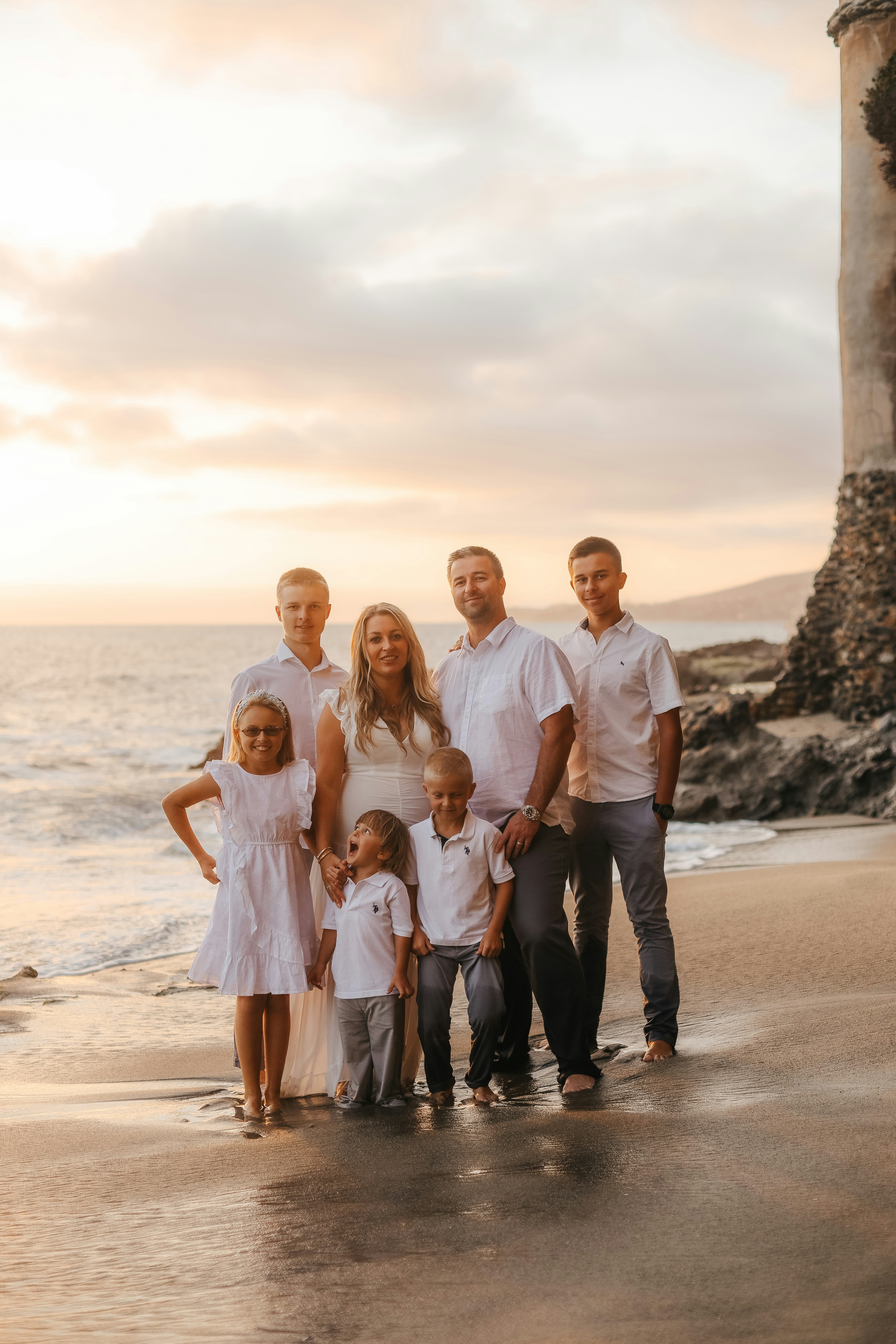 a family posing on a beach