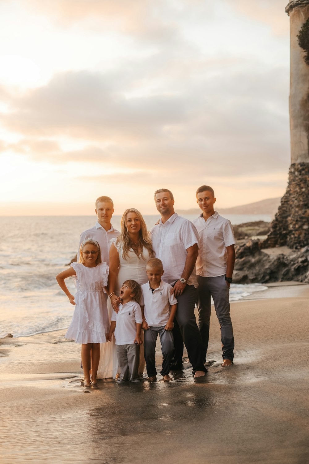 a family posing on a beach