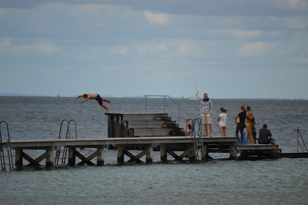 a person jumping off a dock