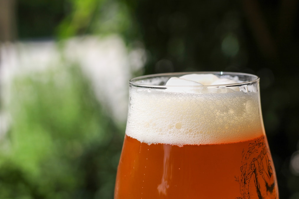 A glass of golden beer poured at a craft brewery taproom