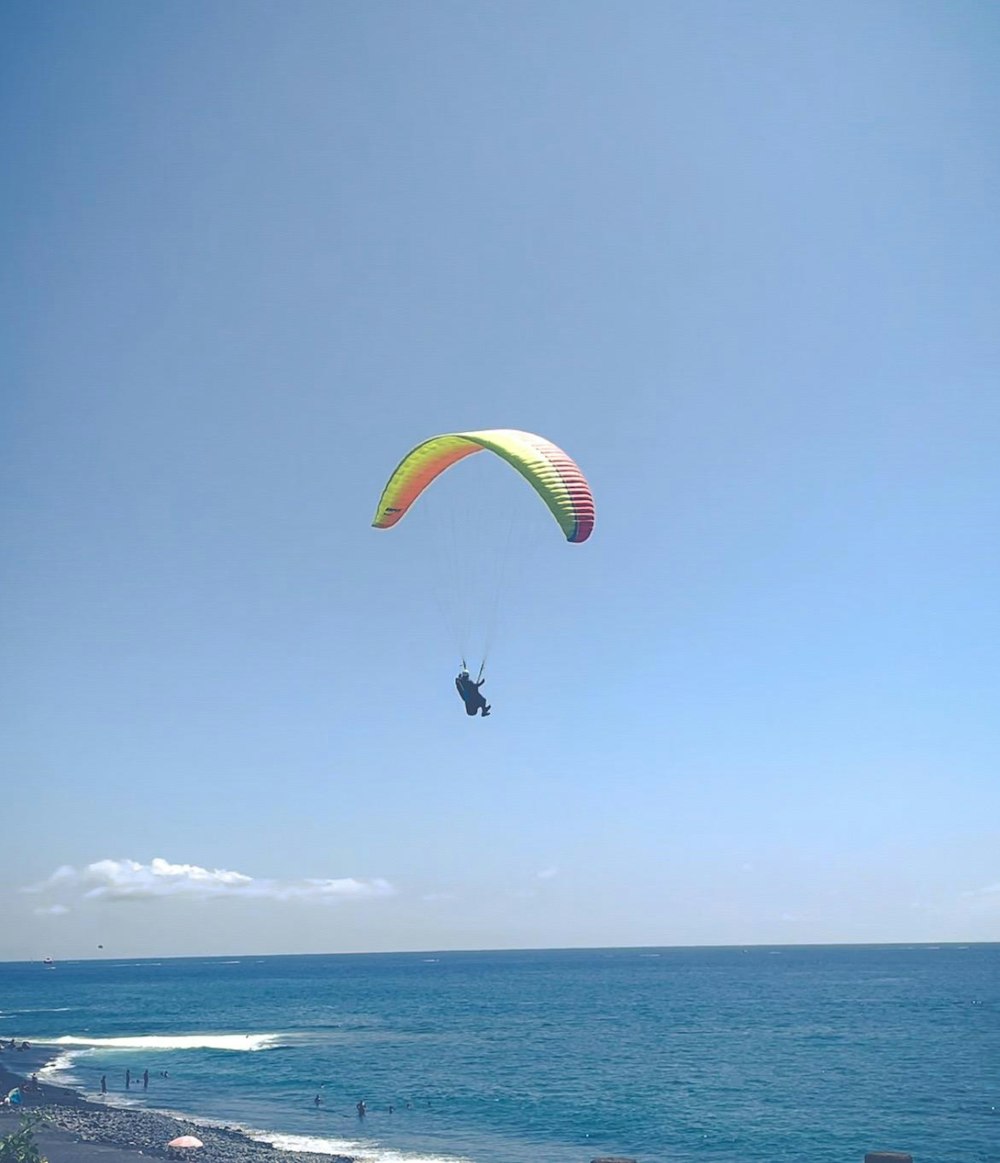 a person parasailing over the ocean