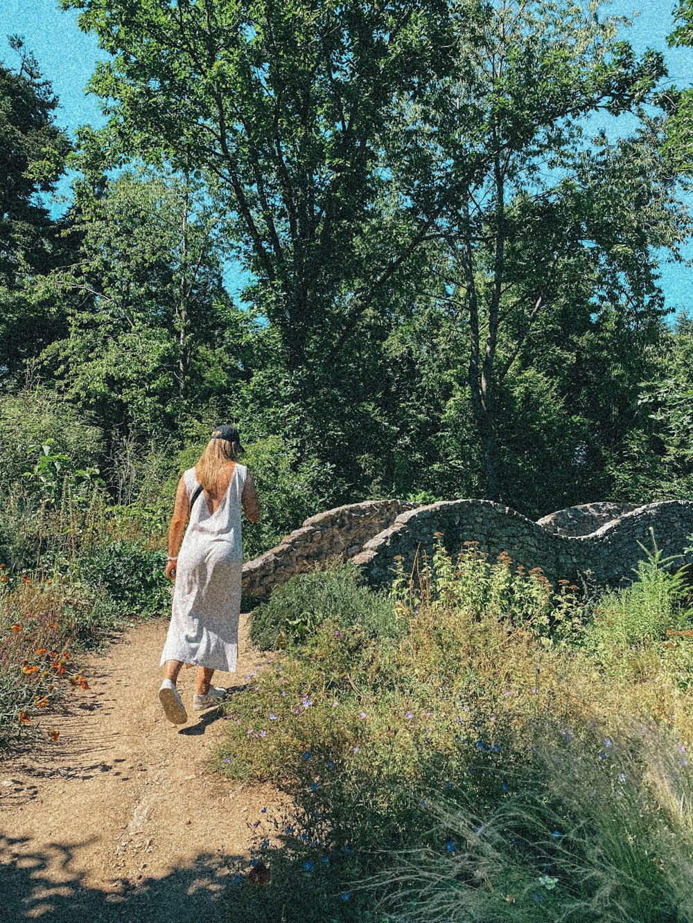 a person walking on a dirt path