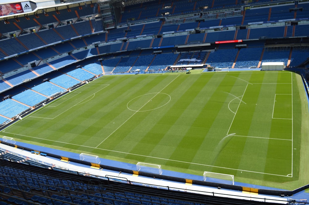 a sports stadium with a green field