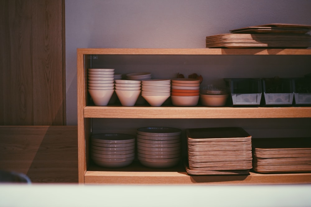 a shelf with bowls and plates on it