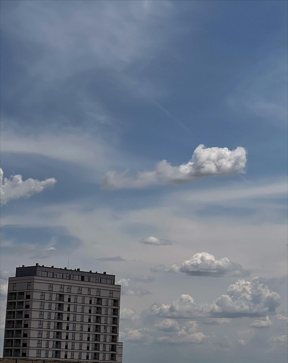 a tall building with a cloudy sky