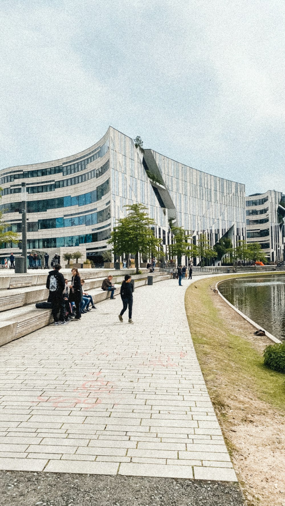 people walking on a path near a building