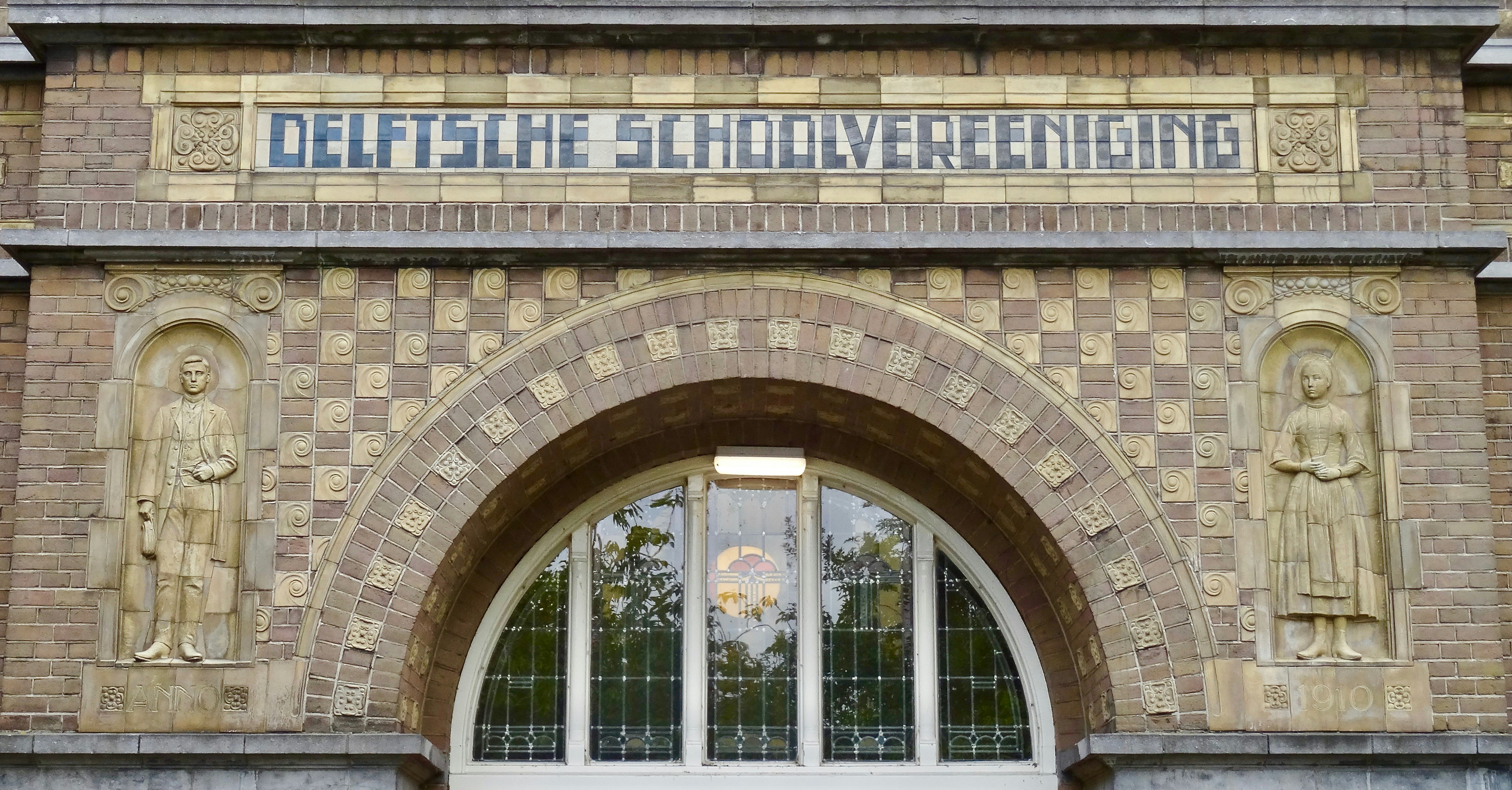 a building with statues and a sign on the front