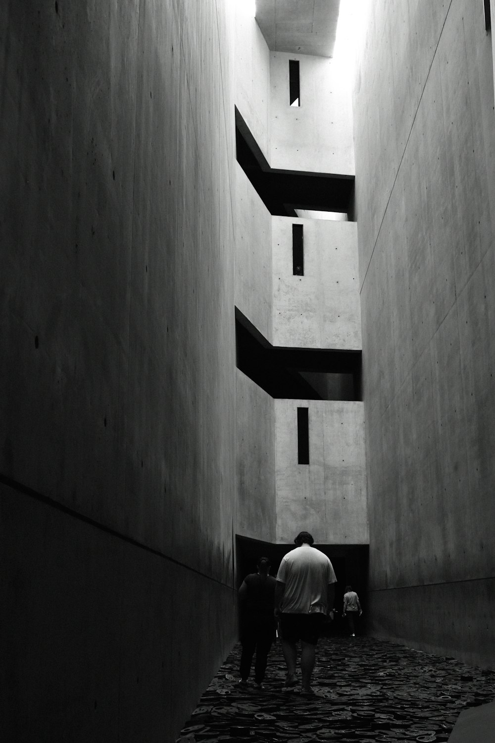 a couple of people walking down a narrow alley