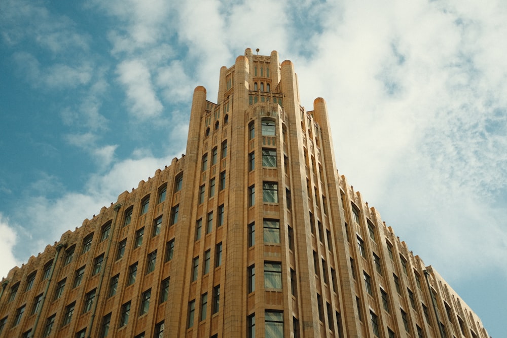 a tall building with a cloudy sky